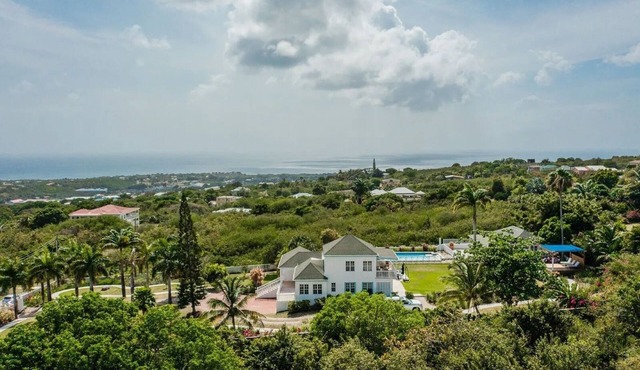 Wake up to ocean views and emerald peaks in this stunning Caribbean sanctuary in Church Ground